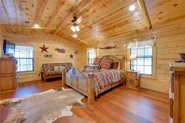 bedroom with wooden ceiling, wooden walls, wood-type flooring, and ceiling fan