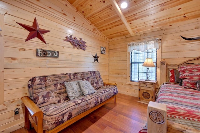 bedroom featuring wood finished floors, wood ceiling, wooden walls, and lofted ceiling
