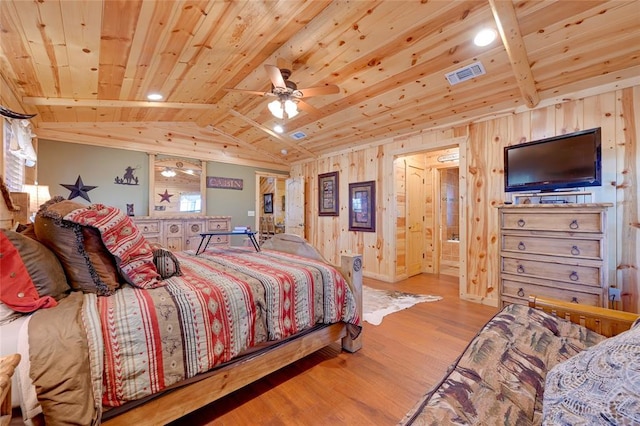 bedroom with wood ceiling, wood finished floors, vaulted ceiling, and wooden walls