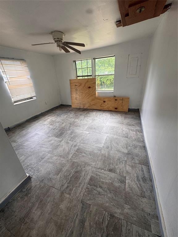 111 N 8th St, Seminole, OK 74868 - spare room featuring a ceiling fan and baseboards