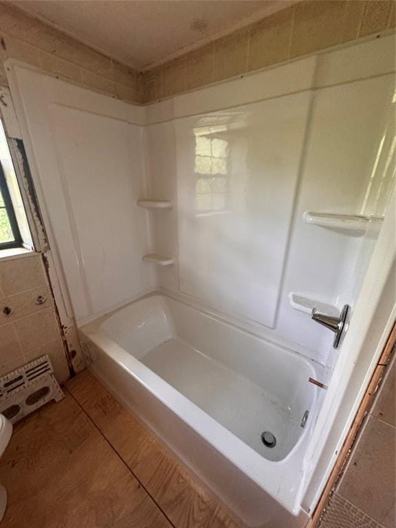111 N 8th St, Seminole, OK 74868 - bathroom featuring a shower, tile patterned floors, and toilet