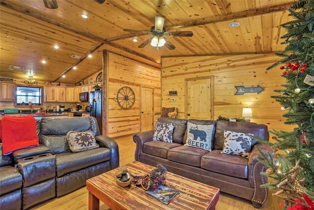 living area with wooden ceiling, lofted ceiling, a ceiling fan, light wood-type flooring, and wood walls