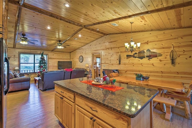 kitchen featuring wooden ceiling, light wood-style flooring, wooden walls, a chandelier, and dark stone counters