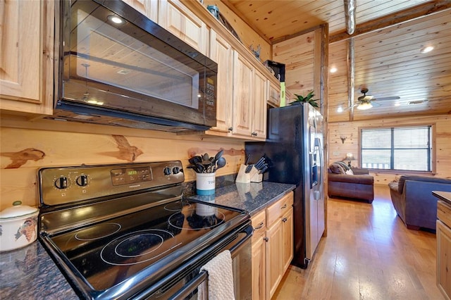 kitchen featuring range with electric cooktop, black microwave, ceiling fan, wooden ceiling, and stainless steel fridge