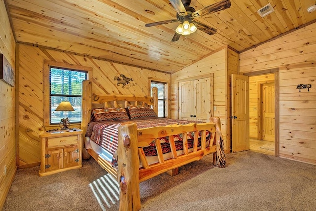 bedroom featuring vaulted ceiling, wooden walls, multiple windows, carpet floors, and wooden ceiling
