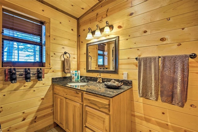 bathroom with wooden walls, vaulted ceiling, vanity, and wooden ceiling