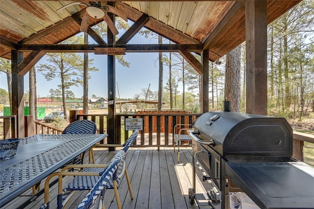 deck featuring a ceiling fan and a grill