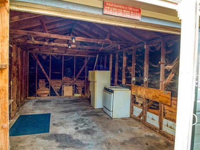 6401 Anderson, Oklahoma City, OK 73149 - miscellaneous room with lofted ceiling and concrete flooring