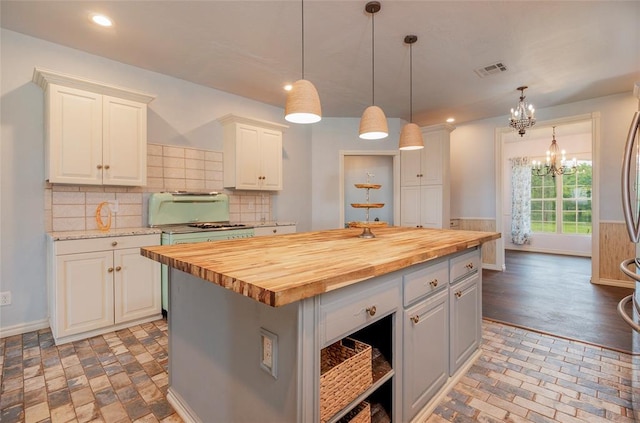 13403 NE 225th St, Fletcher, OK 73541 - kitchen featuring butcher block countertops, white cabinetry, a chandelier, baseboards, and decorative backsplash