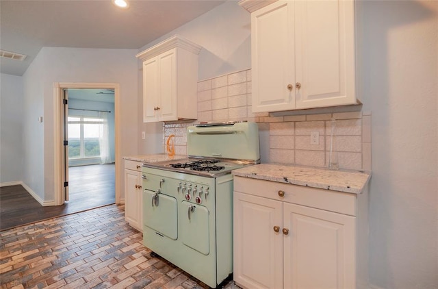 13403 NE 225th St, Fletcher, OK 73541 - kitchen with white range with gas cooktop, backsplash, white cabinets, baseboards, and recessed lighting