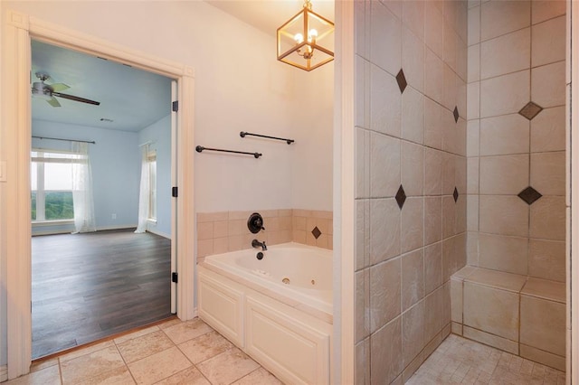 13403 NE 225th St, Fletcher, OK 73541 - bathroom with a tub with jets, a chandelier, and a ceiling fan
