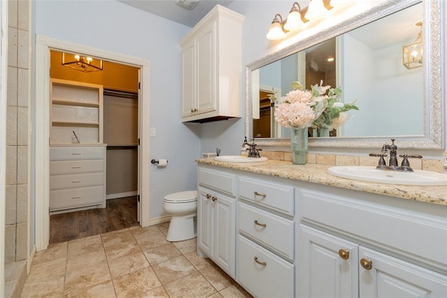 13403 NE 225th St, Fletcher, OK 73541 - full bathroom featuring double vanity, a chandelier, toilet, a spacious closet, and baseboards