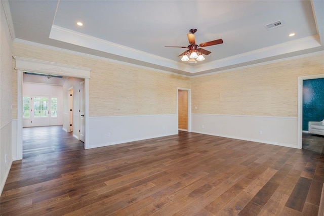 13403 NE 225th St, Fletcher, OK 73541 - unfurnished room with a tray ceiling, crown molding, a ceiling fan, wainscoting, and dark wood-type flooring