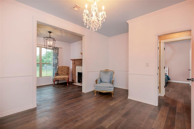 13403 NE 225th St, Fletcher, OK 73541 - sitting room with a chandelier, dark wood finished floors, baseboards, ornamental molding, and a fireplace with flush hearth