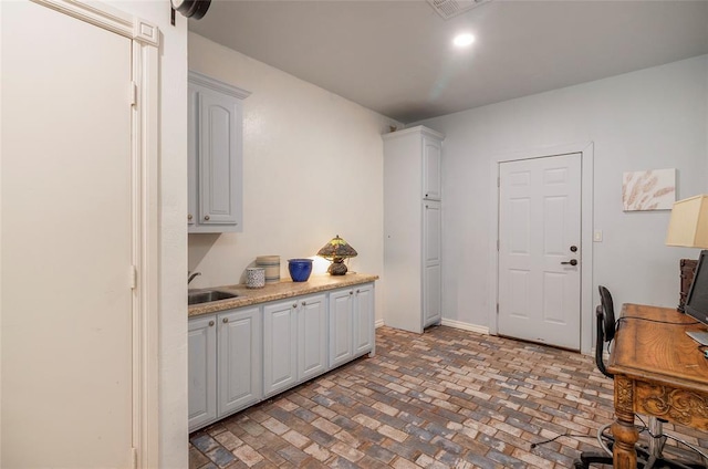 13403 NE 225th St, Fletcher, OK 73541 - kitchen featuring brick patterned floors, a sink, light countertops, an office area, and baseboards