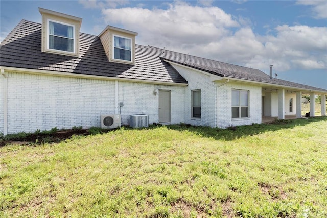 13403 NE 225th St, Fletcher, OK 73541 - back of house featuring a lawn, brick siding, a cooling unit, and cooling unit