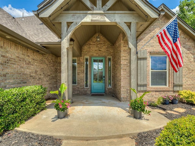 8509 NW 125th St, Oklahoma City, OK 73142 - doorway to property featuring brick siding and a shingled roof