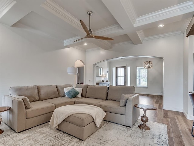 8509 NW 125th St, Oklahoma City, OK 73142 - living room featuring arched walkways, coffered ceiling, crown molding, beamed ceiling, and ceiling fan