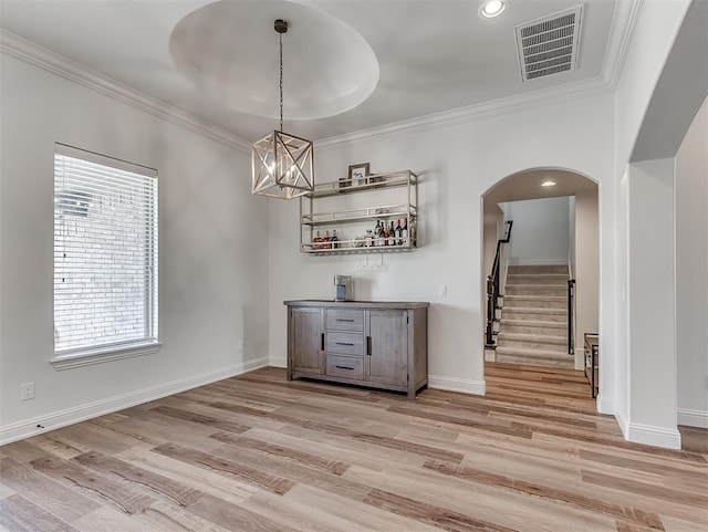 8509 NW 125th St, Oklahoma City, OK 73142 - unfurnished dining area featuring arched walkways, stairway, crown molding, baseboards, and a chandelier