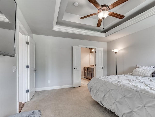 8509 NW 125th St, Oklahoma City, OK 73142 - bedroom featuring a raised ceiling, light colored carpet, baseboards, ensuite bath, and a ceiling fan