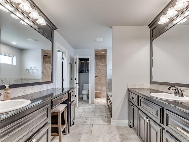 8509 NW 125th St, Oklahoma City, OK 73142 - bathroom with toilet, a tile shower, two vanities, and tile patterned floors