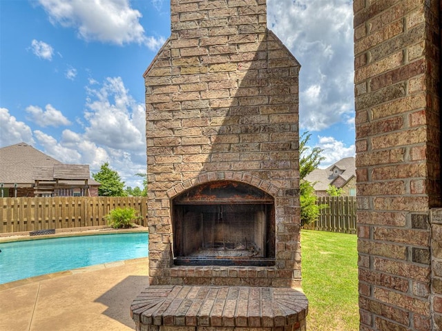 8509 NW 125th St, Oklahoma City, OK 73142 - view of swimming pool featuring an outdoor brick fireplace, a fenced backyard, and a patio area
