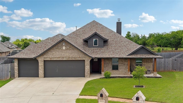 view of front facade with an attached garage, driveway, roof with shingles, a chimney, and brick siding