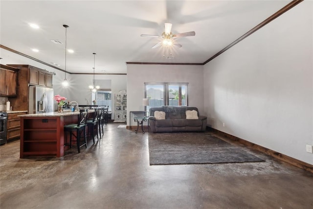living room featuring finished concrete flooring, ceiling fan, crown molding, baseboards, and a chandelier