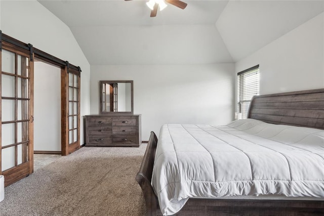 carpeted bedroom featuring lofted ceiling, a barn door, and ceiling fan