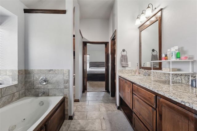 bathroom with ensuite bathroom, a tub with jets, and vanity