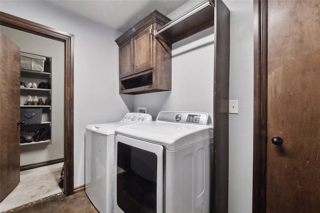 clothes washing area featuring cabinet space and washing machine and dryer