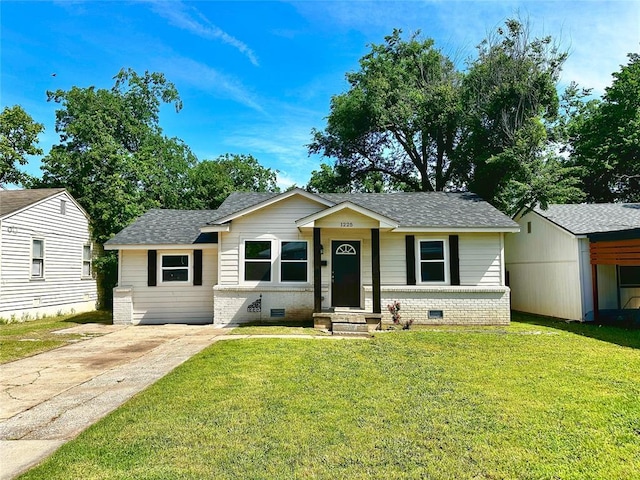1225 NW 99th St, Oklahoma City, OK 73114 - view of front of home featuring a shingled roof, a front yard, and driveway