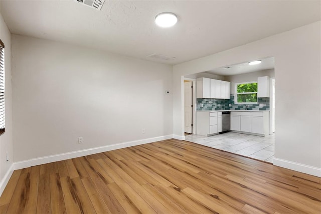 1225 NW 99th St, Oklahoma City, OK 73114 - unfurnished living room with light wood-type flooring and baseboards