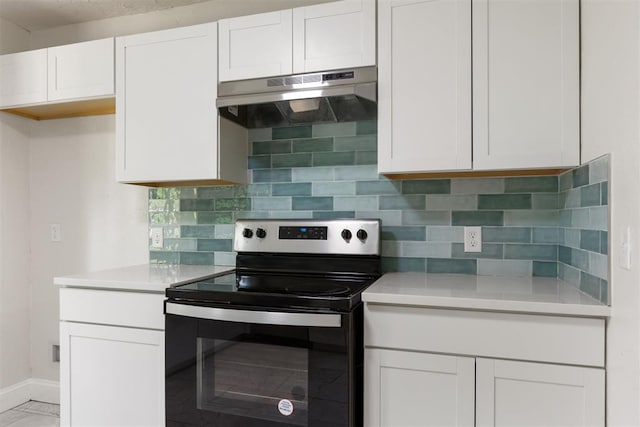 1225 NW 99th St, Oklahoma City, OK 73114 - kitchen with electric range, under cabinet range hood, light countertops, and decorative backsplash