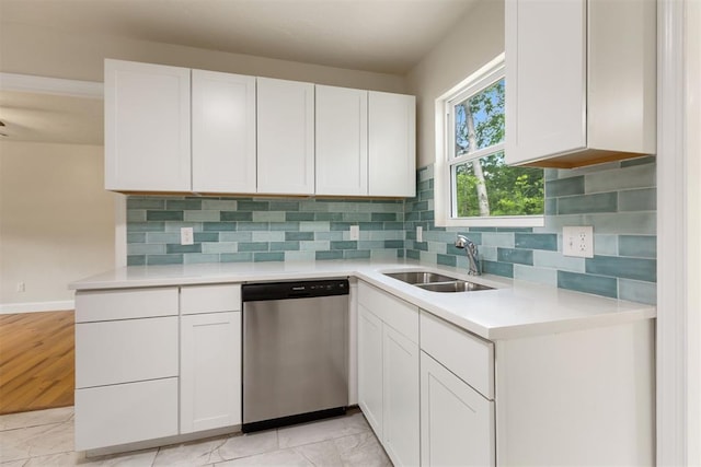 1225 NW 99th St, Oklahoma City, OK 73114 - kitchen with stainless steel dishwasher, white cabinetry, a sink, and light countertops