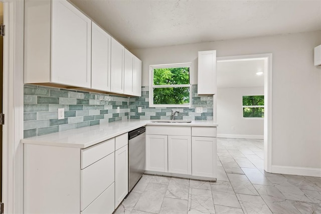 1225 NW 99th St, Oklahoma City, OK 73114 - kitchen with a sink, stainless steel dishwasher, light marble finish flooring, light countertops, and tasteful backsplash