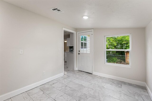 1225 NW 99th St, Oklahoma City, OK 73114 - unfurnished room featuring baseboards and light marble finish floors