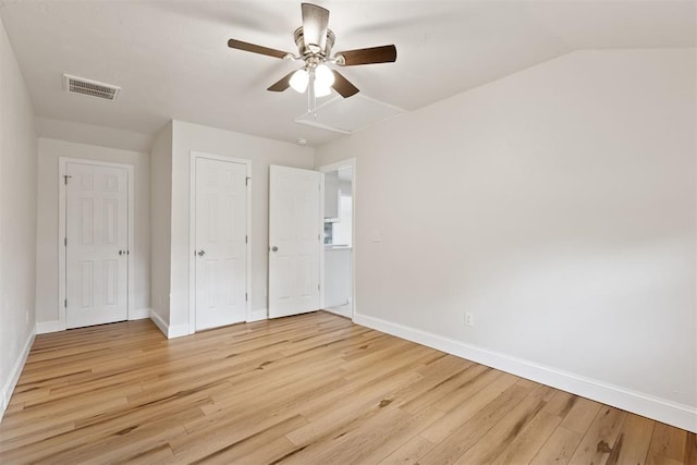 1225 NW 99th St, Oklahoma City, OK 73114 - unfurnished bedroom with light wood finished floors, baseboards, a ceiling fan, attic access, and a closet
