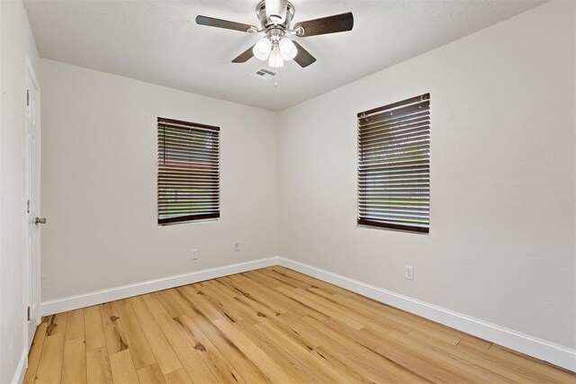 1225 NW 99th St, Oklahoma City, OK 73114 - empty room with wood finished floors, baseboards, and a ceiling fan
