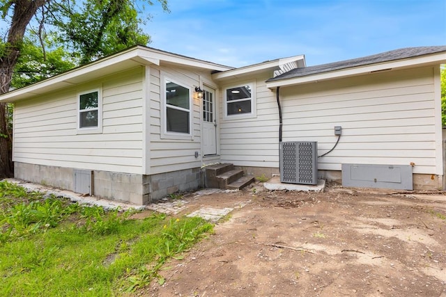 1225 NW 99th St, Oklahoma City, OK 73114 - rear view of property with entry steps and central air condition unit