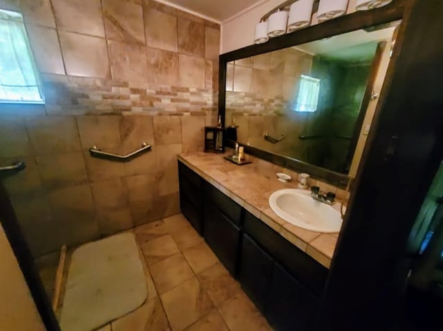 17 S Cemetery Rd, Tuttle, OK 73089 - bathroom featuring double vanity, a tile shower, tile patterned floors, and tile walls