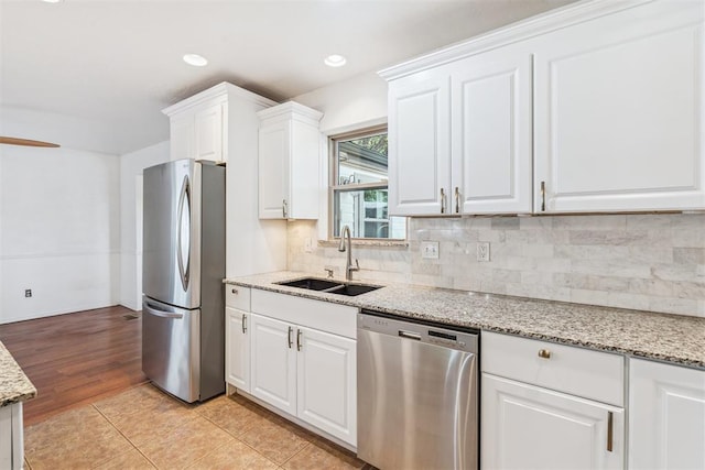 2220 NW 47th St, Oklahoma City, OK 73112 - kitchen featuring stainless steel appliances, white cabinetry, tasteful backsplash, light stone counters, and recessed lighting