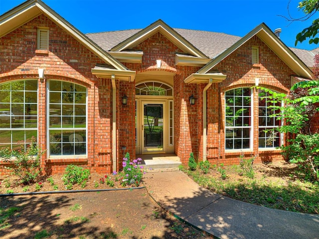 2417 Pawnee Xing, Edmond, OK 73034 - view of front of property with brick siding and roof with shingles