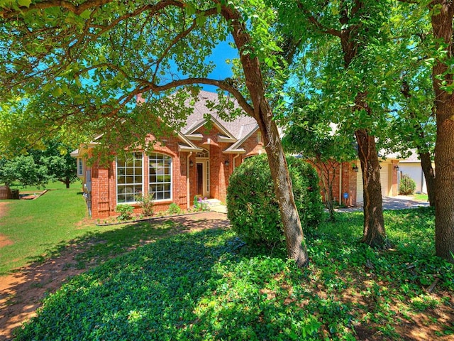 2417 Pawnee Xing, Edmond, OK 73034 - view of front of home featuring brick siding and a front lawn