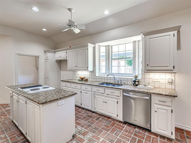 2417 Pawnee Xing, Edmond, OK 73034 - kitchen featuring stainless steel dishwasher, brick flooring, ceiling fan, a sink, and white electric cooktop