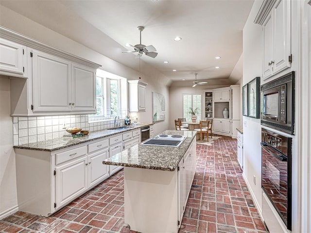 2417 Pawnee Xing, Edmond, OK 73034 - kitchen featuring black appliances, brick floors, ceiling fan, recessed lighting, and white cabinets