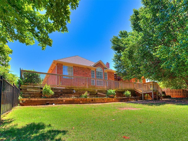 2417 Pawnee Xing, Edmond, OK 73034 - back of house featuring brick siding, a deck, a chimney, and stairway