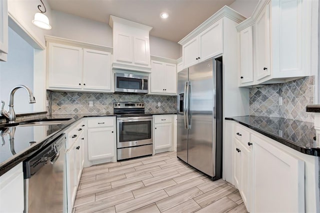 kitchen with a sink, stainless steel appliances, backsplash, and recessed lighting