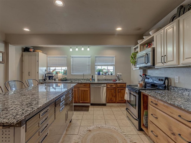 1072 County St Unit 2958, Tuttle, OK 73089 - kitchen featuring stainless steel appliances, dark stone countertops, a sink, recessed lighting, and light tile patterned flooring