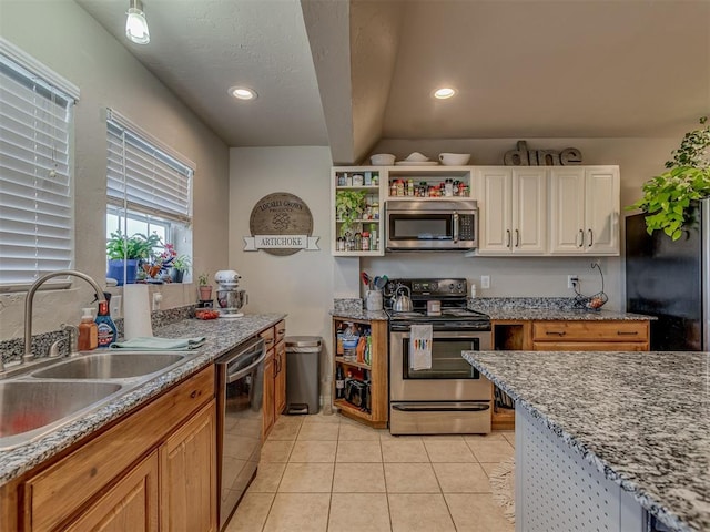 1072 County St Unit 2958, Tuttle, OK 73089 - kitchen featuring appliances with stainless steel finishes, a sink, light tile patterned floors, recessed lighting, and white cabinets